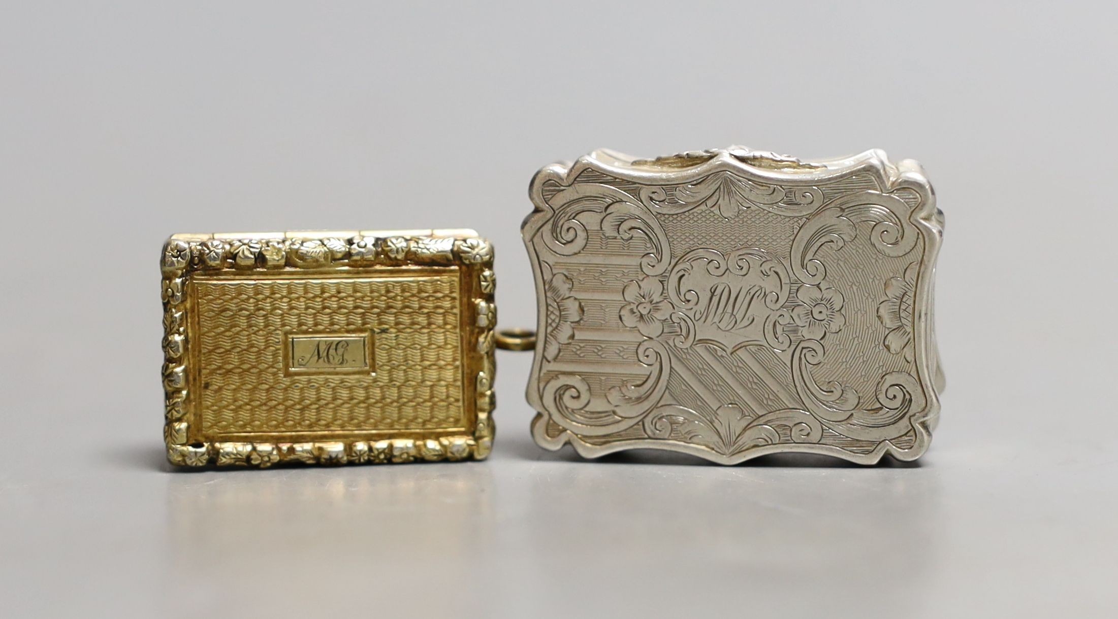 A George IV engine turned silver gilt vinaigrette, by Thomas Parker, Birmingham, with later bale,(date letter illegible), 30mm and a later vinaigrette by Nathaniel Mills, Birmingham, 1846, 36mm.